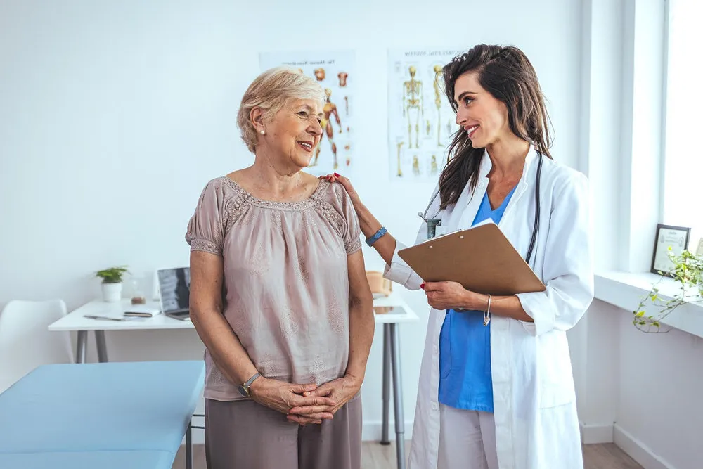 Doctor speaking with an elderly patient during a medical appointment